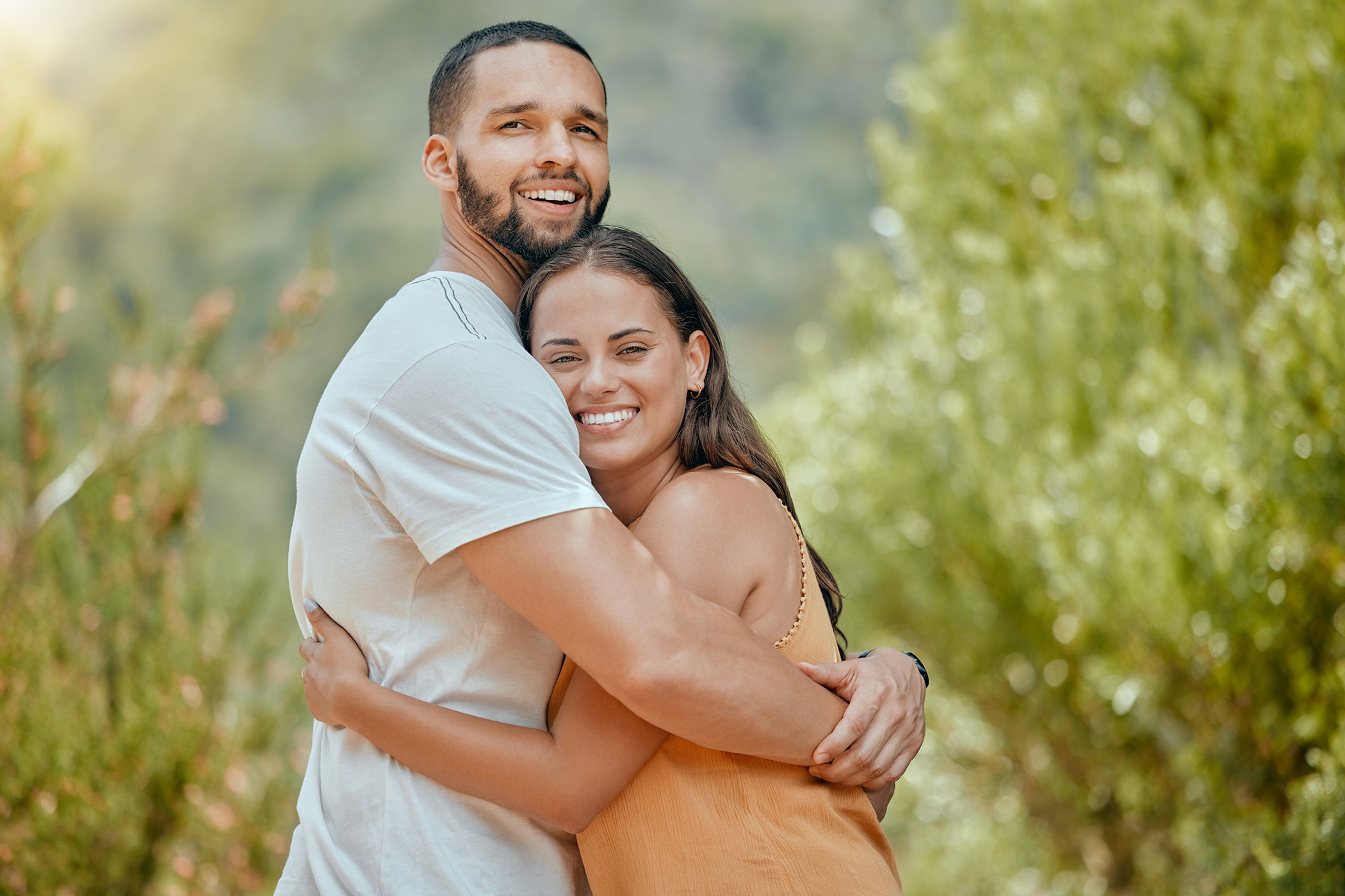 Happy couple embracing outdoors