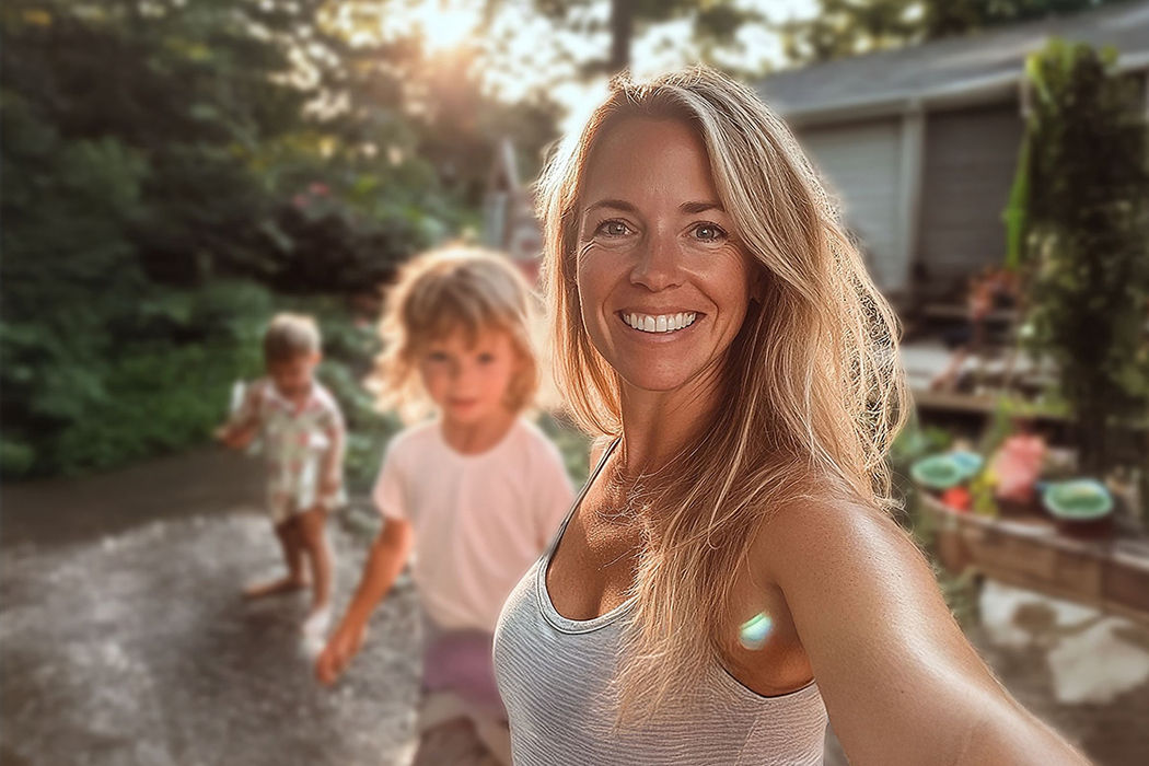 Healthy young mother taking outdoor selfie with kids in natural sunlight