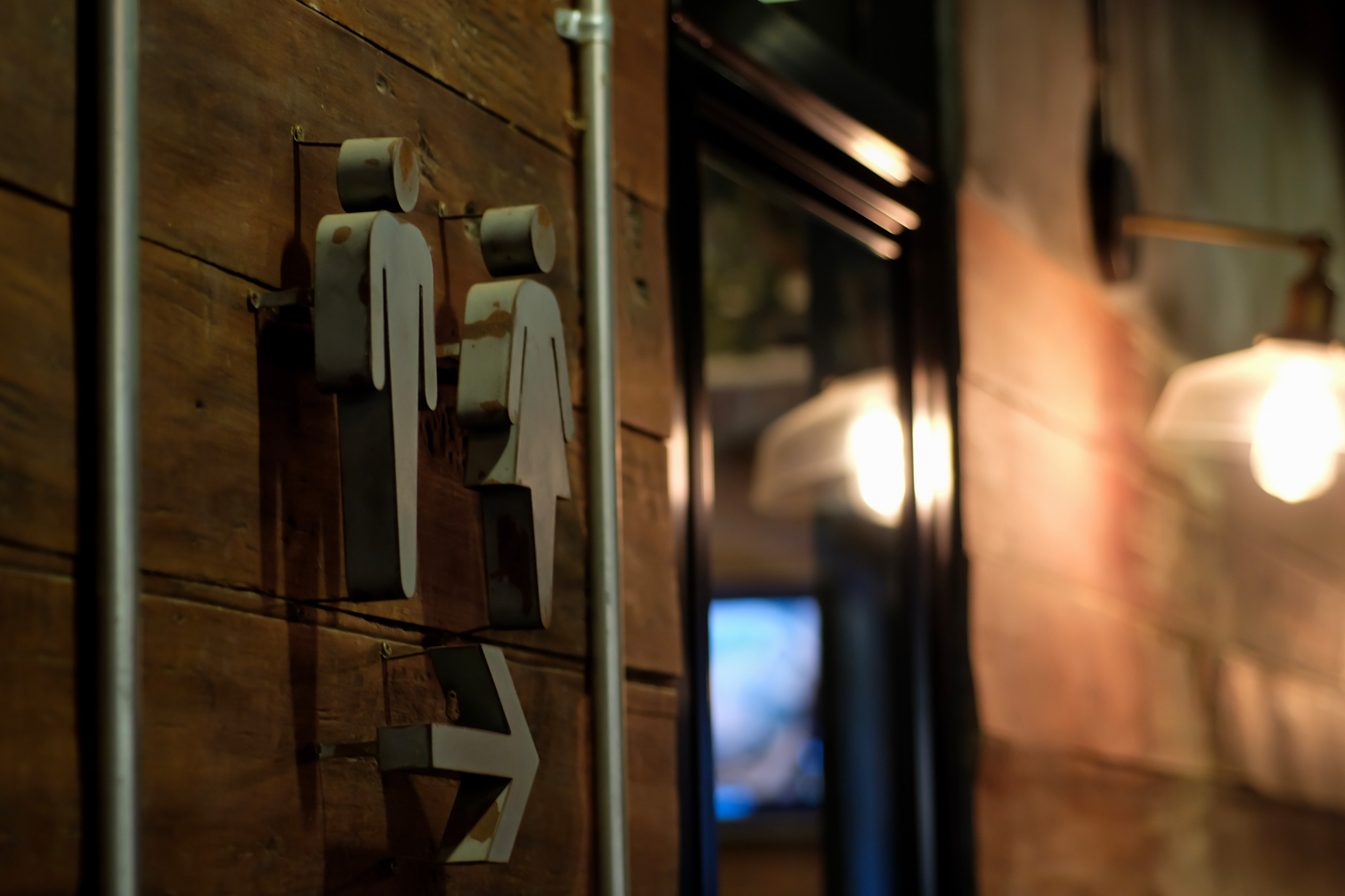 Dimly lit restroom sign