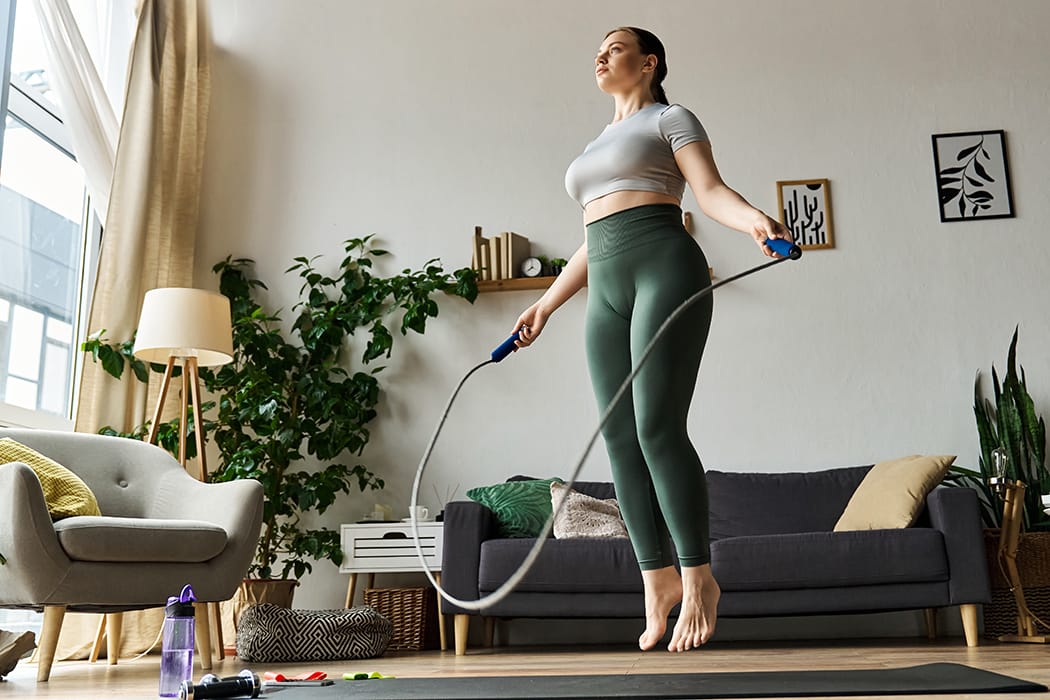 Healthy fit woman jumping rope in a home setting