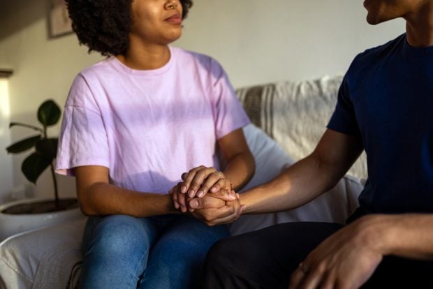 couple-holding-hands-talking-1050x700
