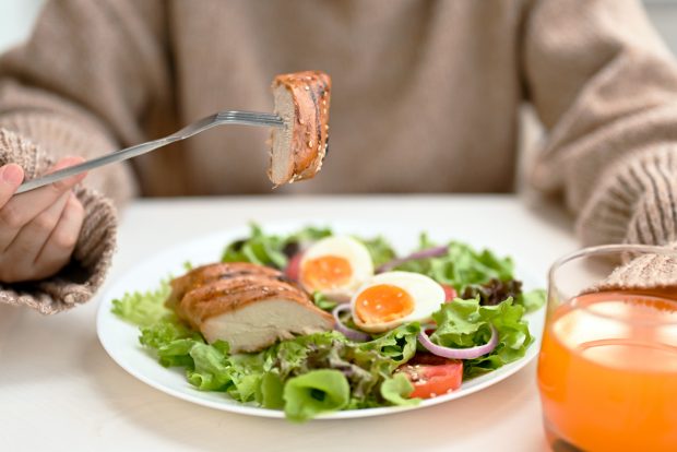 A beautiful bowl of salad with grilled chicken and sliced hard boiled eggs