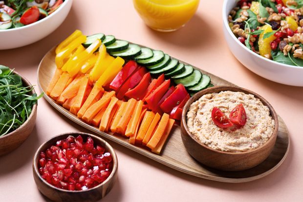 Platter of healthy fruits, veggies and hummas