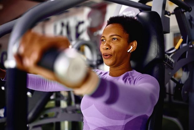 Woman lifting weights on a bench press machine