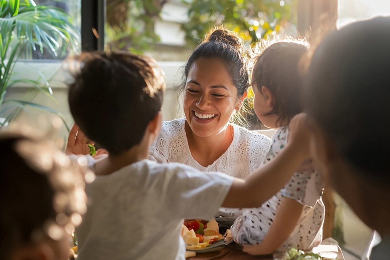 A happy smiling woman enjoying healthy snack with her children
